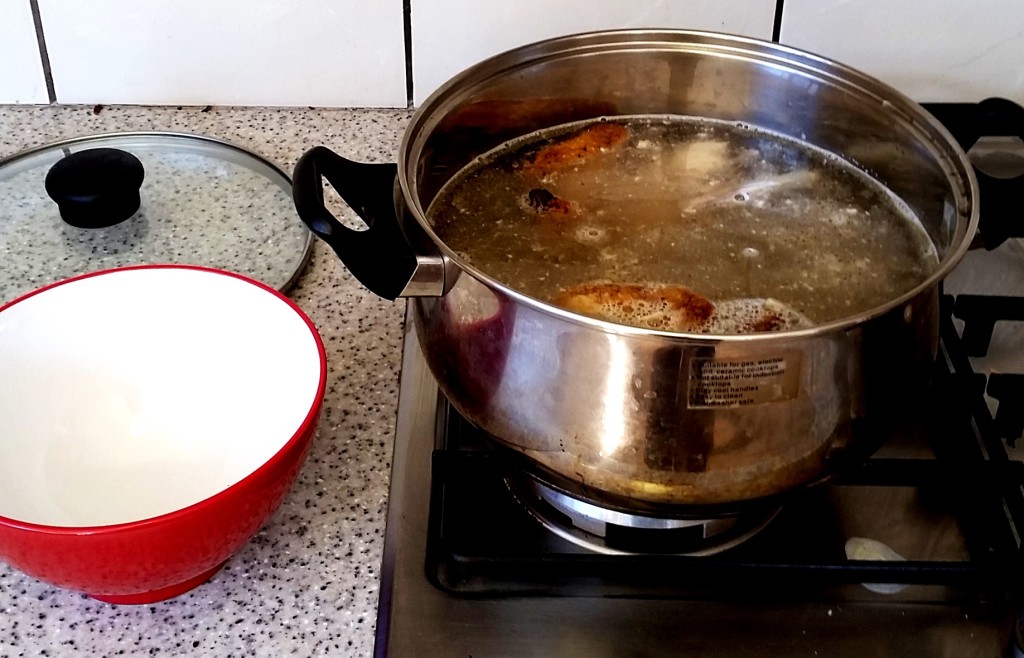 healthy chicken broth on the stove